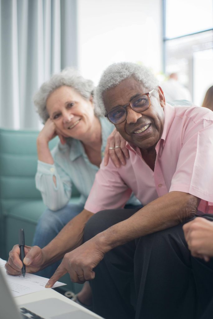 Seniors smiling signing living assisted home